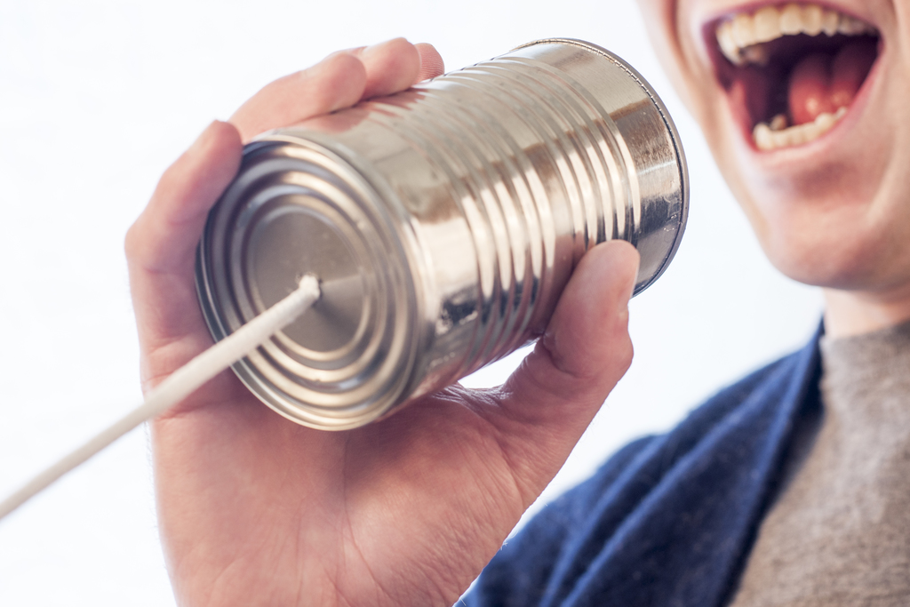 woman tin can talking word of mouth marketing term