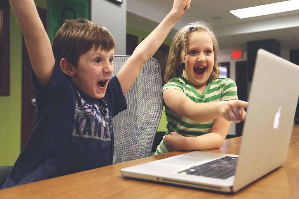 kids celebrate computer coding in library